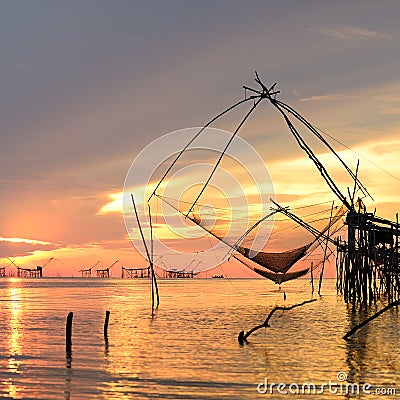 Square dip net catch fish during sunrise Stock Photo