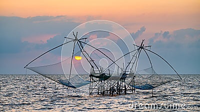 Square dip net with sunrise at Pakpra Stock Photo