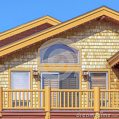 Square Exterior of home in Park City Utah with sunlit colorful wall against blue sky Stock Photo