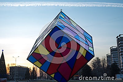 A figure in the city center resembles a multi-colored cube shot at sunset in a winter evening Editorial Stock Photo