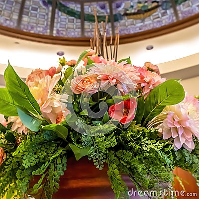 Square frame Beautiful potted colorful flowers with leaves under stained glass dome roof Stock Photo