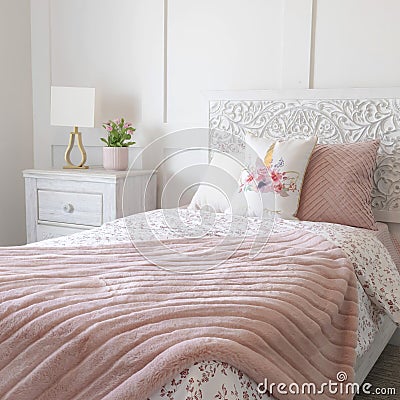 Square frame Bedroom interior with floral feminine beddings and decorative headboard on bed Stock Photo