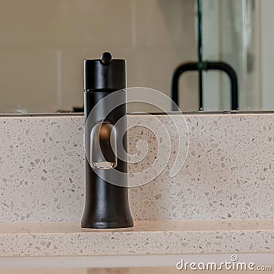 Square frame Black faucet on white countertop with undermount sink inside bathroom of home Stock Photo