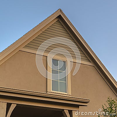 Square frame Top floor window in roof apex on a modern house Stock Photo