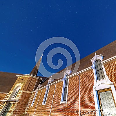 Square frame Vivid blue sky over a church in Provo Utah with brick wall and arched windows Stock Photo