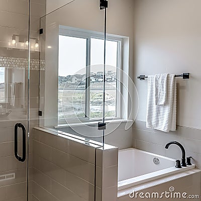 Square Frameless walk in shower stall and built in bathtub inside tile wall bathroom Stock Photo