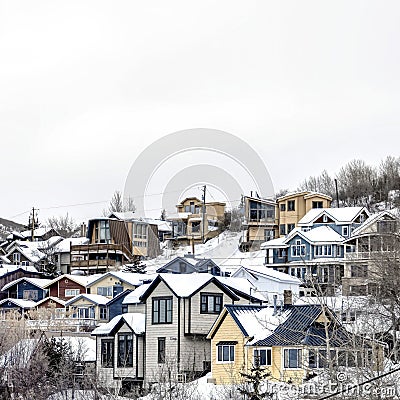 Square Houses on residential hill in Park City Utah with snow dusted slopes in winter Stock Photo