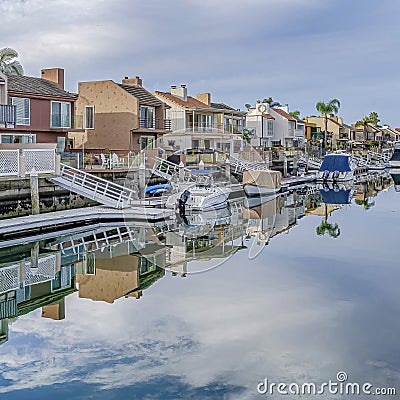 Square Huntington Beach California scenery with homes overlooking the road and canal Stock Photo