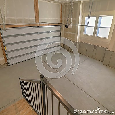 Square Interior of a garage with automatic sectional door operator machine Stock Photo