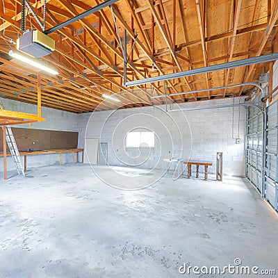 Square Large garage interior with automatic door operator machine Stock Photo