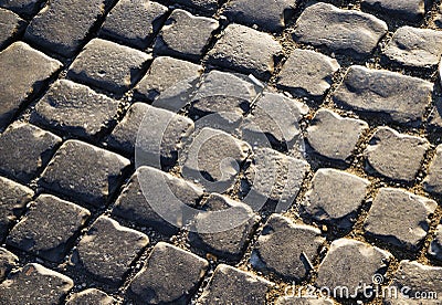Square lined with cobblestone or stone pavement, walkway or road. The surface of rough stones and rough. The cobbles Stock Photo