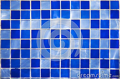 Square pattern of blue and light blue tiles for bath walls and floor design or swimming pool design. Water blinks on tiled walls i Stock Photo