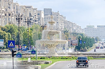 The square Piata Unirii with shops, traffic cars, people. Bucharest, Romania Editorial Stock Photo