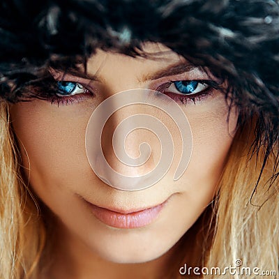 Square portrait of cutie young woman with blond hair and blue eyes in fur hat Stock Photo