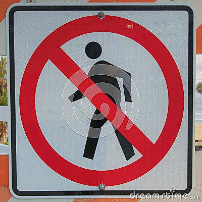 Square Puffy clouds at sunset No jaywalking sign on a white and orange barricade at Oceanside, Stock Photo