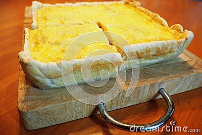 Square quiche bacon with vegetables on wooden cutboard Stock Photo