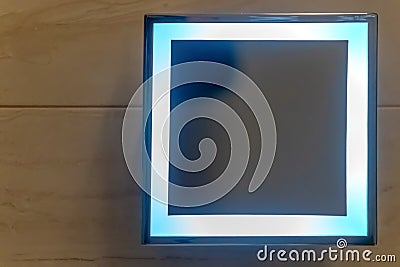 Square shape mirror with LED light mounth on white wall in restroom. Square mirror in the bathroom Stock Photo