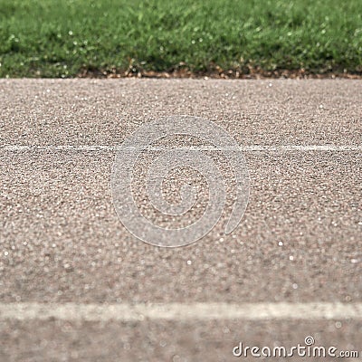 Texture paved road with markings on the background of green grass. Part of the photo is in blur. Stock Photo