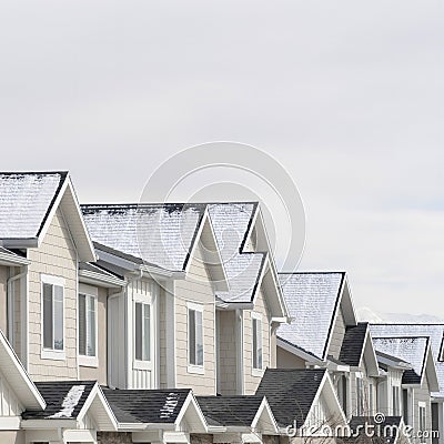 Square Townhouses with snowy gable roofs in South Jordan Utah on a cloudy winter day Stock Photo