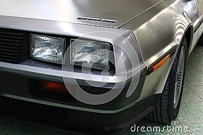 Square twin headlights on front mask of classical US two passenger sports car DeLorean DMC-12 Editorial Stock Photo