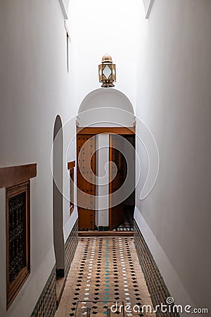 Squared colourful tiles floor on an ancient historic building gate in Arabian style in Marrakesh, Morocco Stock Photo