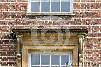 Squared Pediment above Window in Brick Wall Stock Photo