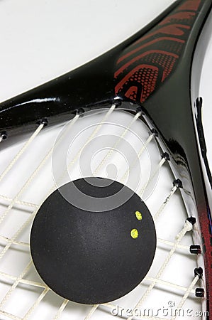 Squash ball on a racket Stock Photo