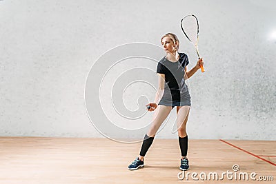 Squash game training, female player with racket Stock Photo