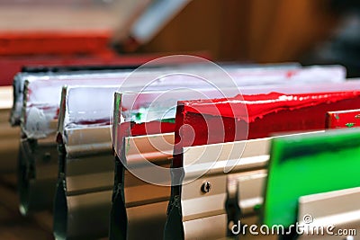 squeegees close-up on wooden shelve of the print screening apparatus. silk screen printmaking. serigraphy production Stock Photo