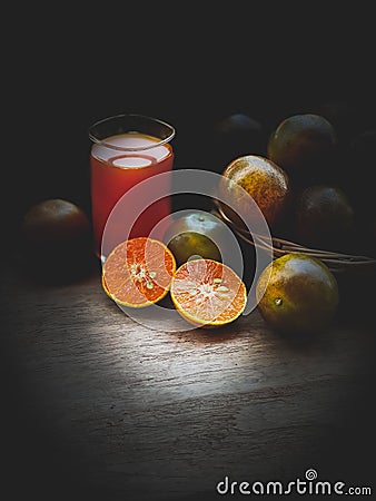 Squeezed orange juice in dark scene Stock Photo