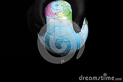 squeezing globe and the last bit of water dropping down concept of human overusing the water resource Stock Photo