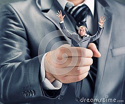 Squeezing small businessman Stock Photo