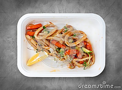 Squid pasta. Healthy food. Takeaway food. Top view, on a gray background Stock Photo