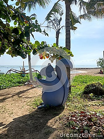 Squirrel statue sitting on the edge of Sanur beach Editorial Stock Photo