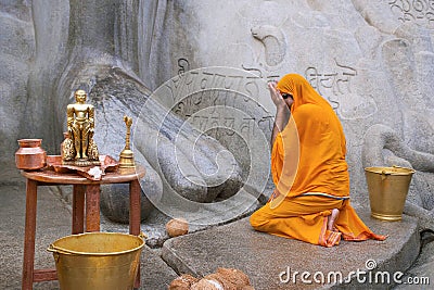 SRAVANABELGOLA, KARNATAKA, MAY 2016, Priest offers worship to gigantic statue of Bahubali, Chandragiri hill Editorial Stock Photo