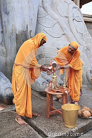 SRAVANABELGOLA, KARNATAKA, MAY 2016, Priests offer worship to gigantic statue of Bahubali, Chandragiri hill Editorial Stock Photo