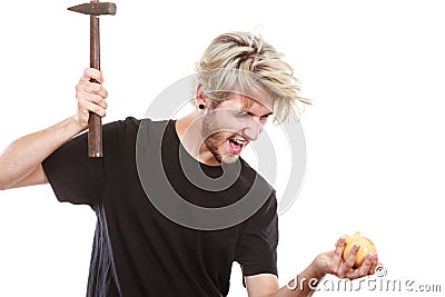 Sreaming man trying break piggy bank with hammer Stock Photo