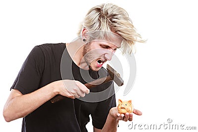 Sreaming man trying break piggy bank with hammer Stock Photo