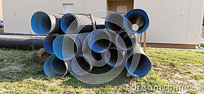 Sremska Mitrovica, Serbia, 23 August 2020. Metal corrugated pipes, blue inside. Plumbing or heating pipes lie on the ground next Stock Photo