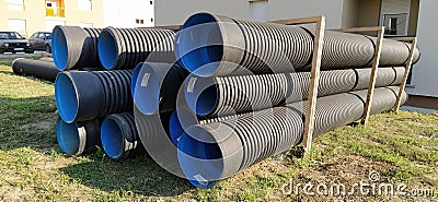 Sremska Mitrovica, Serbia, 23 August 2020. Metal corrugated pipes, blue inside. Plumbing or heating pipes lie on the ground next Editorial Stock Photo