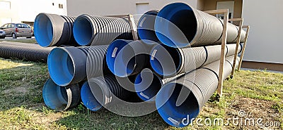 Sremska Mitrovica, Serbia, 23 August 2020. Metal corrugated pipes, blue inside. Plumbing or heating pipes lie on the ground next Editorial Stock Photo