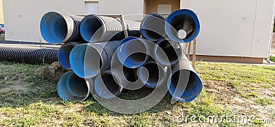 Sremska Mitrovica, Serbia, 23 August 2020. Metal corrugated pipes, blue inside. Plumbing or heating pipes lie on the ground next Editorial Stock Photo