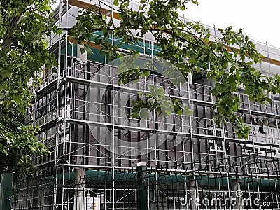 Sremska Mitrovica, Serbia, May 30, 2020. Construction of a new school building. Scaffolding on the facade. Metal fence Editorial Stock Photo