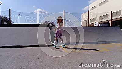 Sremska Mitrovica, Serbia, September 12, 2020. The girl is rollerblading on the asphalt. A 7-year-old child in a striped white and Editorial Stock Photo