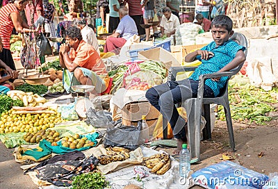 Sri Lanka island, Weligama, February 2020. Editorial image. A teenager sells vegetables at the local market Editorial Stock Photo