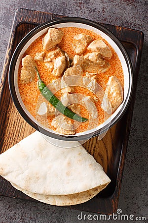 Sri Lankan Chicken Curry Kukul Mas with coconut milk and aromatic spices closeup in the bowl. Vertical top view Stock Photo