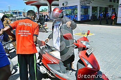 A Sri Lankan motorcyclist obtains his weekly quota of petrol at a fuel station in Colombo, Sri Lanka Editorial Stock Photo