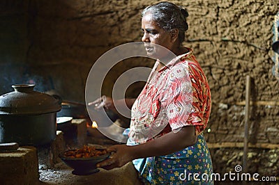 Polonnaruwa, Sri Lanka, November 8, 2015: Sri Lankian old woman preparing food in kitchen in traditional way Editorial Stock Photo