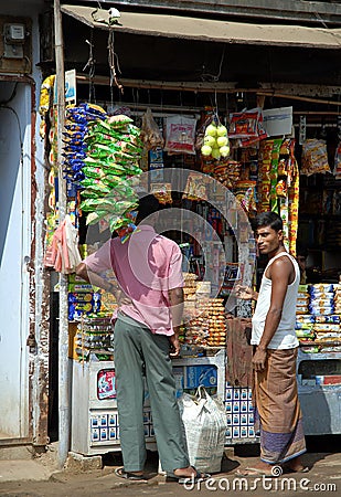 Srimangal in Sylhet Division, Bangladesh. Two men at a small store Editorial Stock Photo