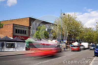 St Albans-UK - 19 May 2021 - People shopping and walking on busy retail high street with market stalls and shops Editorial Stock Photo